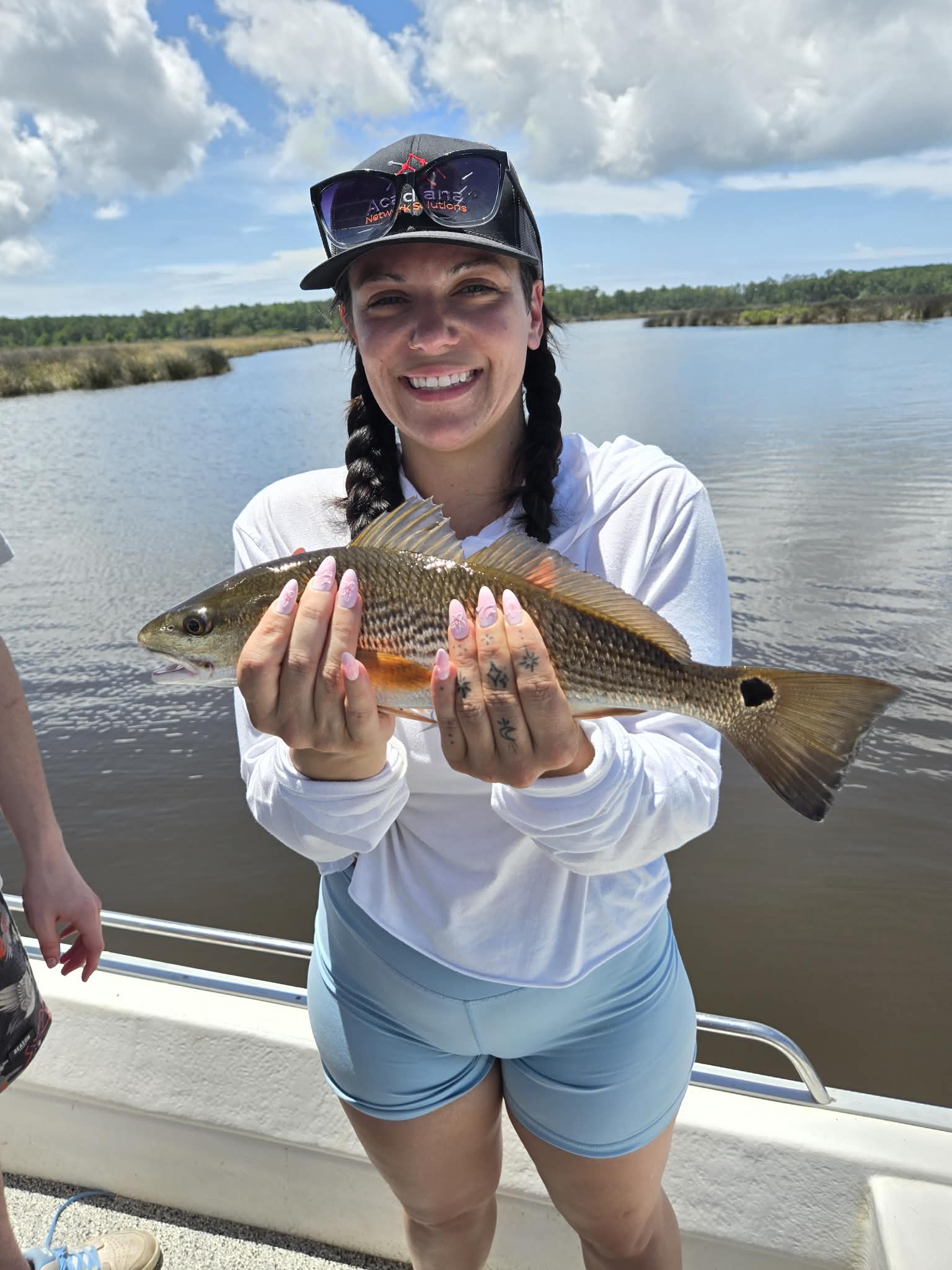Guest holding an inshore catch on a 30A fishing charter