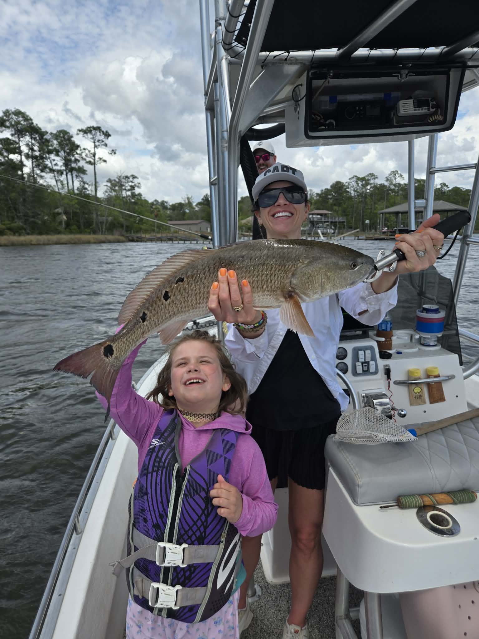 Young angler enjoying a private 30A fishing charter