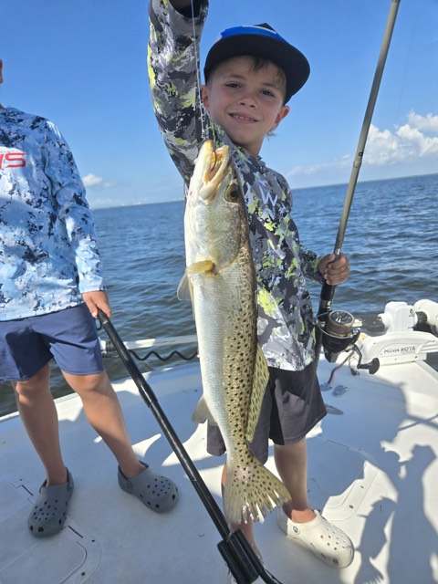 Guest displaying a large redfish caught near 30A