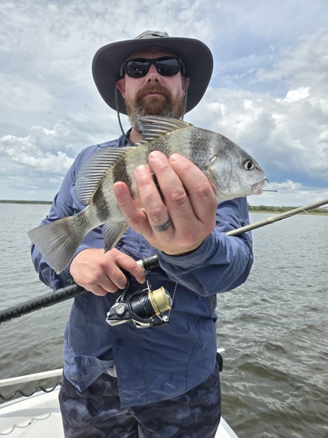 Young angler holding a trout on Captain Marvin’s boat