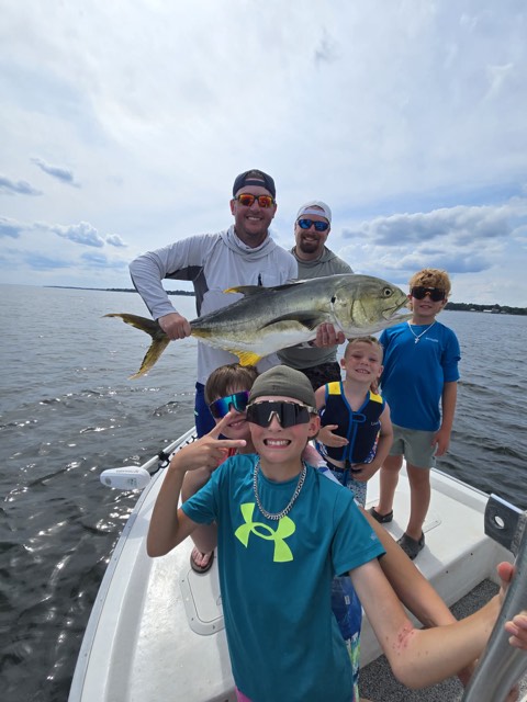 Young angler showing a shark caught with Captain Marvin