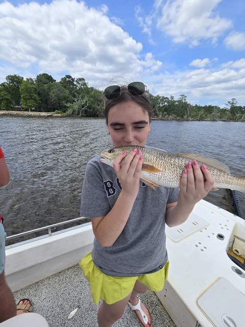 Guest smiling with a colorful catch from Northwest Florida waters