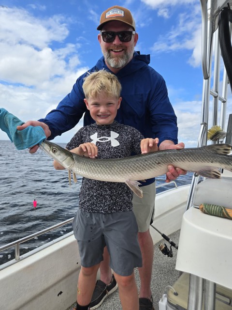 Angler holding a hard-fighting jack on a 30A fishing trip