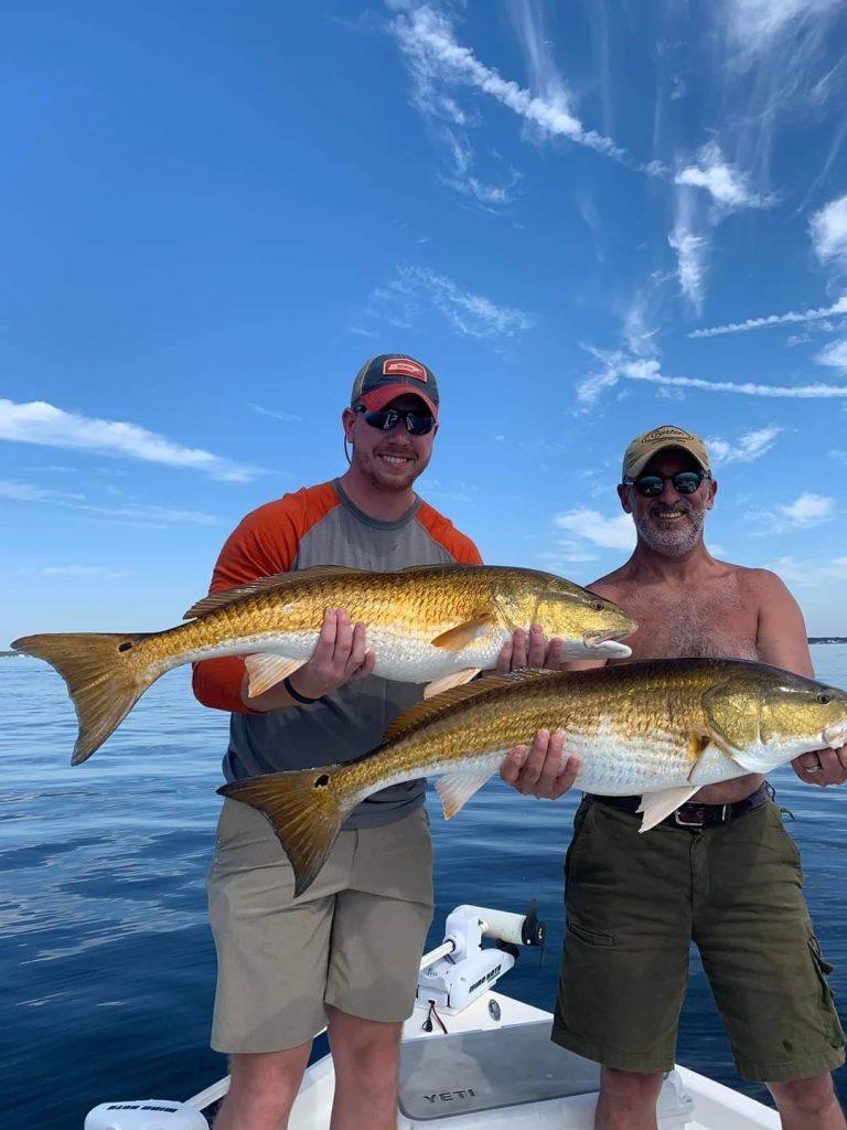 Large redfish caught on light spinning tackle during 30A bay fishing charter in Choctawhatchee Bay